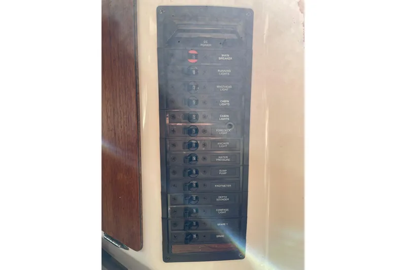 Slide: The Image of Electrical panel on a 1982 Sabre 34 sailboat, featuring various labeled switches. - 22