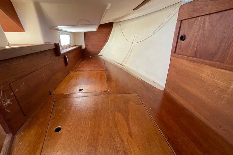 Slide: The Image of Interior of 1982 Sabre 34 sailboat with wooden paneling and storage compartments. - 23
