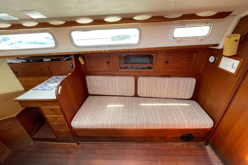 Slide: The Image of Interior of 1982 Sabre 34 sailboat with wooden cabinetry and cushioned seating. - 26
