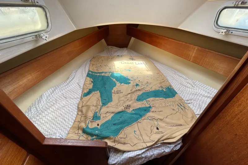 Slide: The Image of Cozy cabin bed in 1982 Sabre 34 sailboat with Great Lakes map blanket. - 28