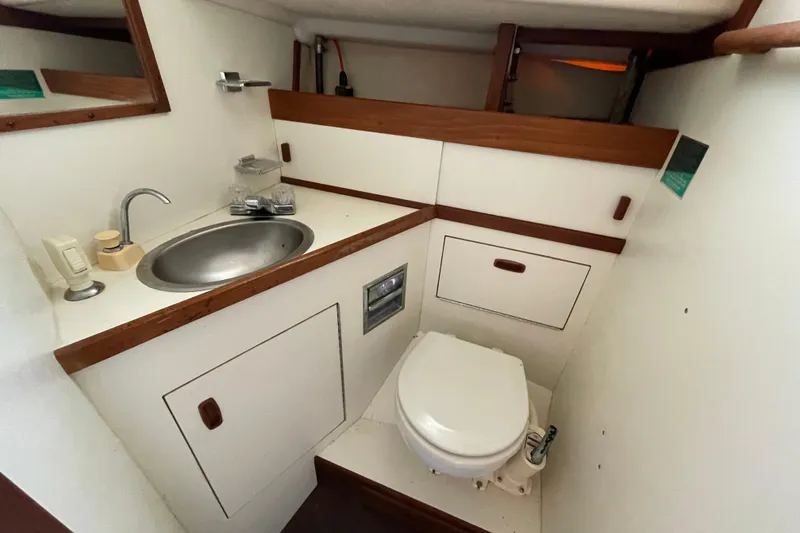 Slide: The Image of Compact bathroom in a 1982 Sabre 34 sailboat with sink and toilet. - 29