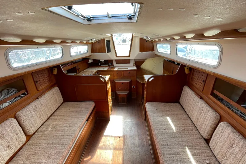 Slide: The Image of Interior of a 1982 Sabre 34 sailboat with wooden furnishings and cozy seating. - 30