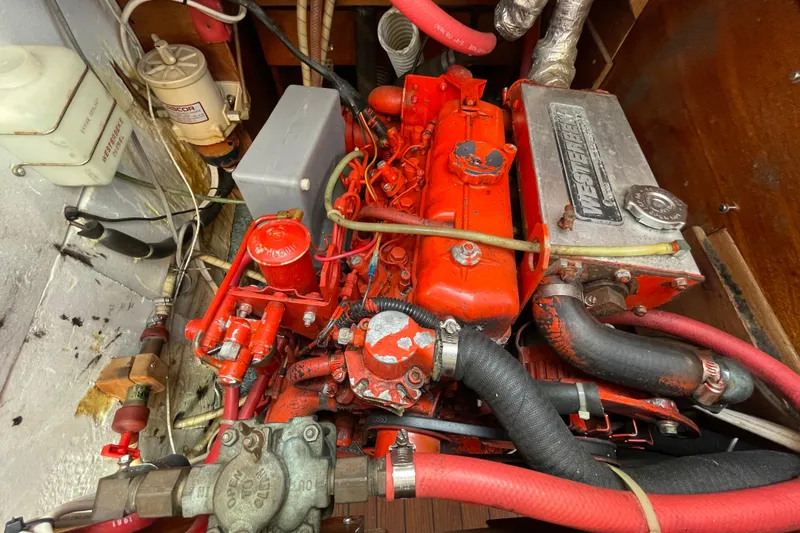 Slide: The Image of Engine compartment of a 1982 Sabre 34 sailboat, featuring a red Westerbeke engine. - 32