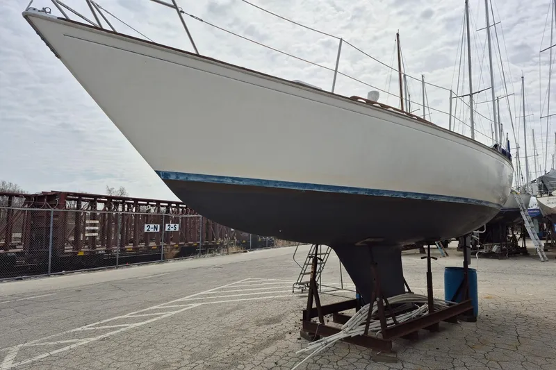 Slide: The Image of 1982 Sabre 34 sailboat on dry dock, showcasing hull and keel design. - 4