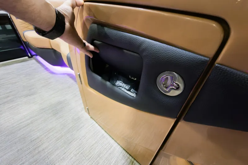 Slide: The Image of Hand opening storage compartment on 2026 Godfrey Monaco 235 Single Flip Lounge boat. - 11