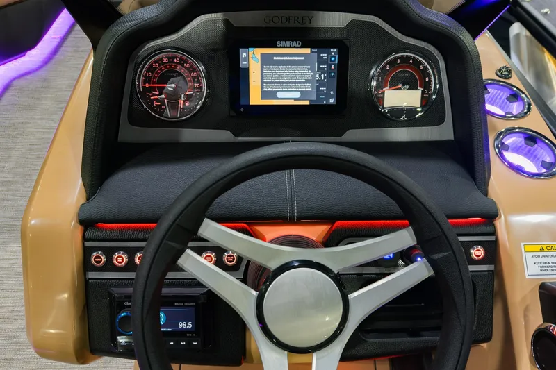 Slide: The Image of 2026 Godfrey Monaco 235 dashboard with steering wheel, digital display, and illuminated controls. - 14