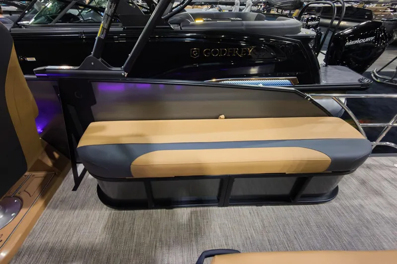 Slide: The Image of 2026 Godfrey Monaco 235 boat with tan and gray flip lounge seating. - 20