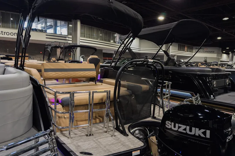 Slide: The Image of 2026 Godfrey Monaco 235 SFL boat with Suzuki engine, showcased indoors. - 4