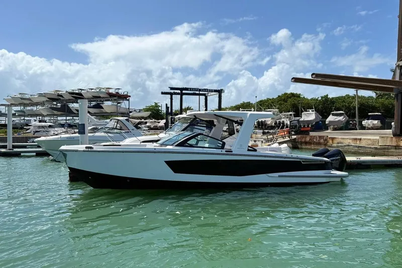 The Image of 2023 Aviara 32AV boat docked in marina under clear blue sky. - 0