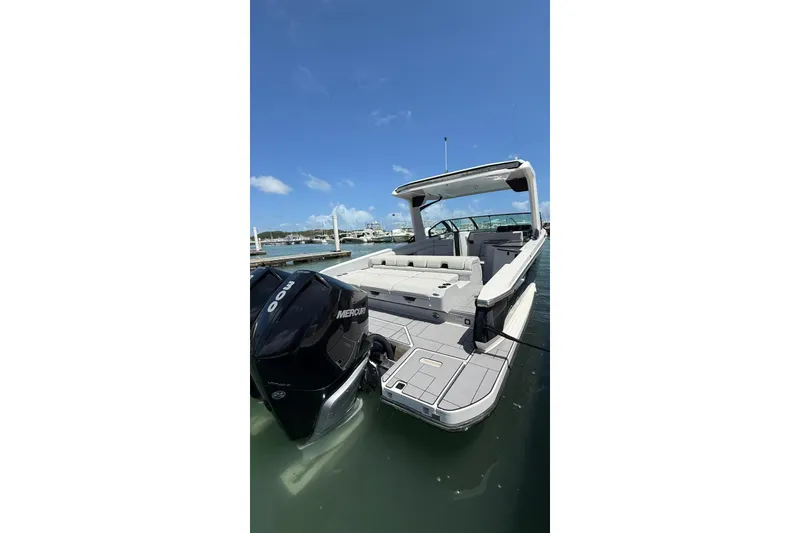 Slide: The Image of 2023 Aviara 32AV boat with Mercury engine docked in sunny marina. - 3