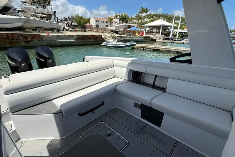Slide: The Image of 2023 Aviara 32AV boat interior with white seating and twin Mercury engines. - 4