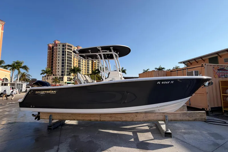 The Image of 2023 Sportsman Open 232 Center Console boat on display, urban backdrop. - 0