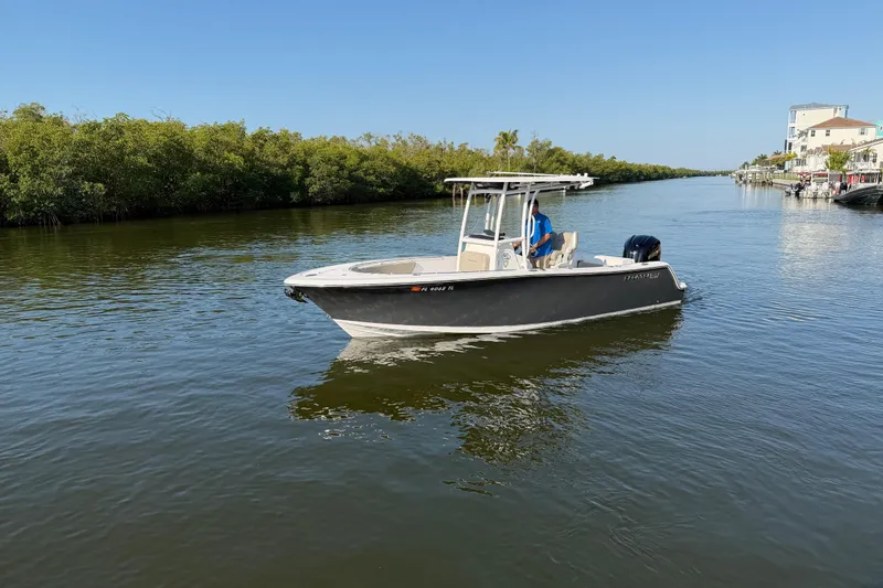 Slide: The Image of 2023 Sportsman Open 232 Center Console boat cruising on a calm river. - 11
