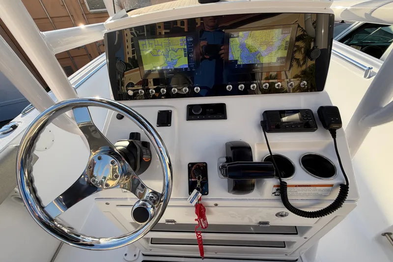 Slide: The Image of 2023 Sportsman Open 232 Center Console dashboard with steering wheel and navigation screens. - 16