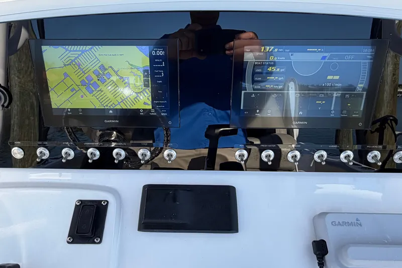 Slide: The Image of 2023 Sportsman Open 232 Center Console dashboard with dual Garmin displays and control switches. - 17