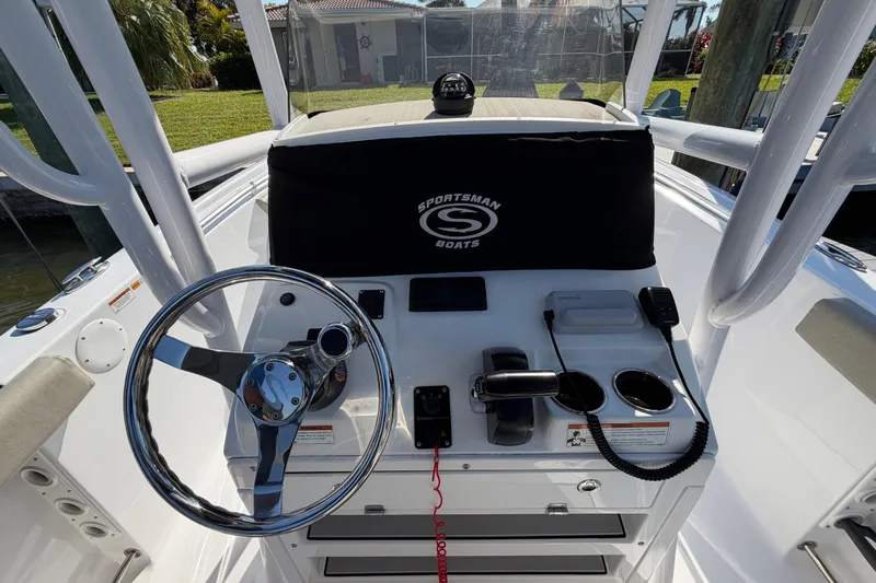 Slide: The Image of 2023 Sportsman Open 232 Center Console boat dashboard with steering wheel and controls. - 24