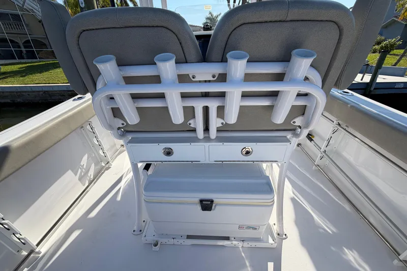 Slide: The Image of 2023 Sportsman Open 232 Center Console boat seating with rod holders and storage. - 25