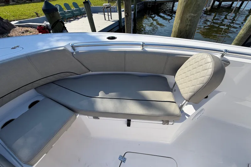 Slide: The Image of 2023 Sportsman Open 232 Center Console boat with cushioned seating and sleek design. - 32