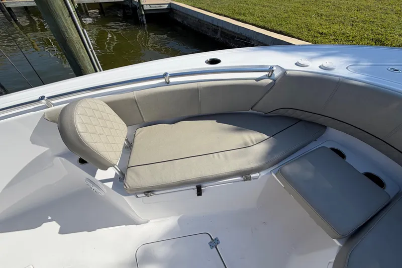 Slide: The Image of 2023 Sportsman Open 232 Center Console boat with cushioned seating area. - 33