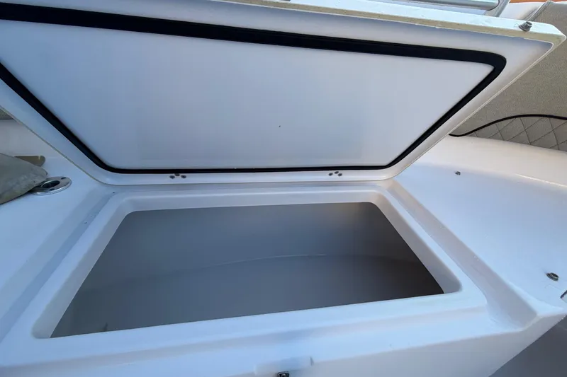 Slide: The Image of Open storage compartment on 2023 Sportsman Open 232 Center Console boat. - 38