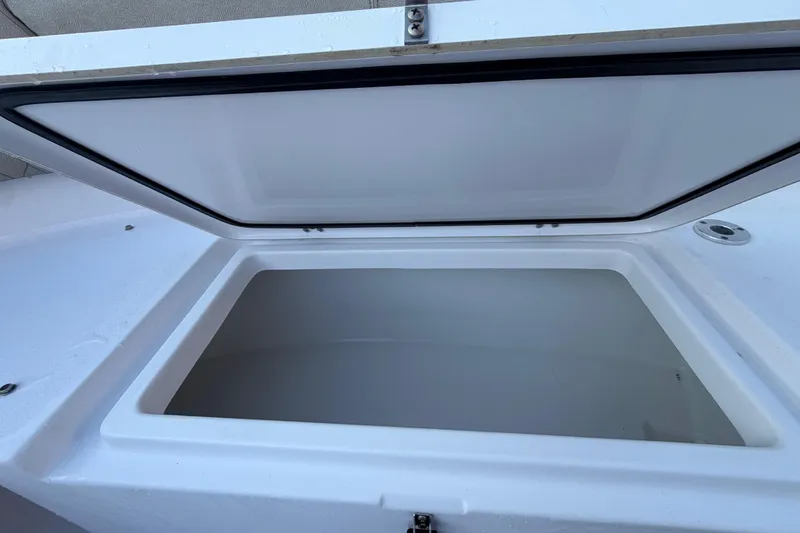 Slide: The Image of Open storage compartment on 2023 Sportsman Open 232 Center Console boat. - 39