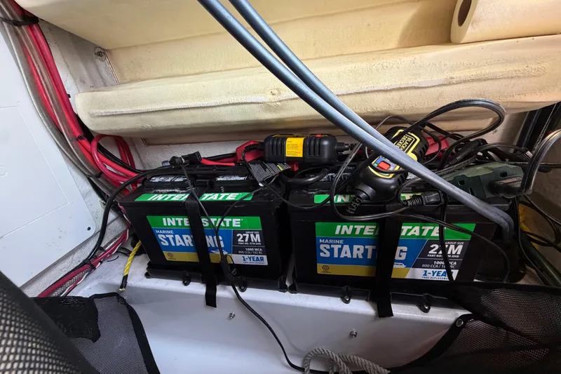 Slide: The Image of Marine batteries and wiring inside a 2023 Sportsman Open 232 Center Console boat. - 42