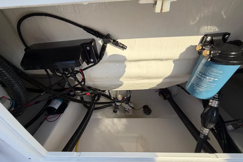 Slide: The Image of 2023 Sportsman Open 232 Center Console boat wiring and components inside compartment. - 44