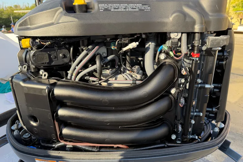 Slide: The Image of Close-up of a 2023 Sportsman Open 232 Center Console engine components. - 45