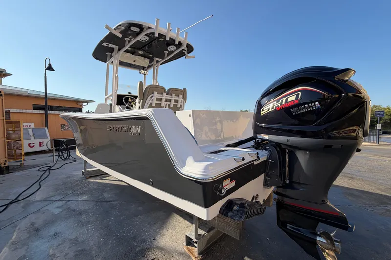 Slide: The Image of 2023 Sportsman Open 232 Center Console boat with Yamaha engine, docked outdoors. - 5