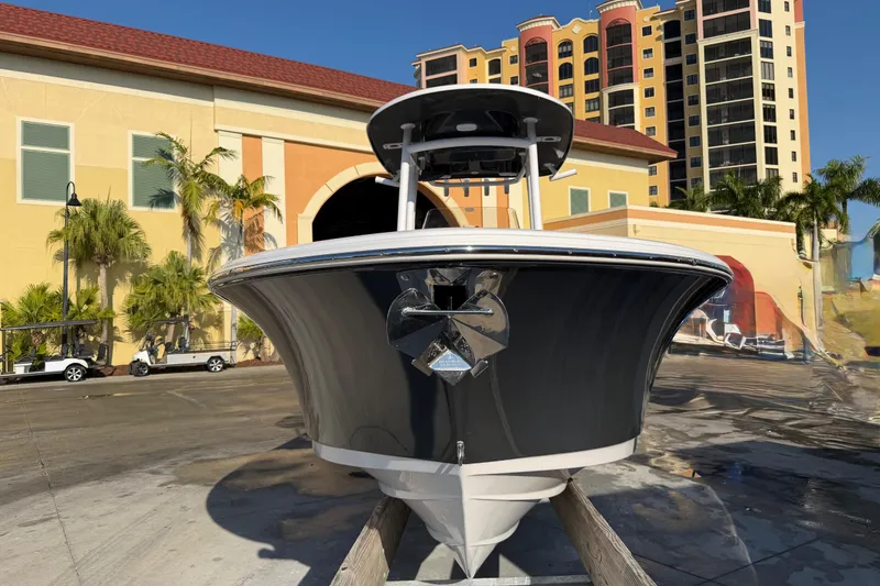 Slide: The Image of 2023 Sportsman Open 232 Center Console boat docked near colorful buildings. - 6