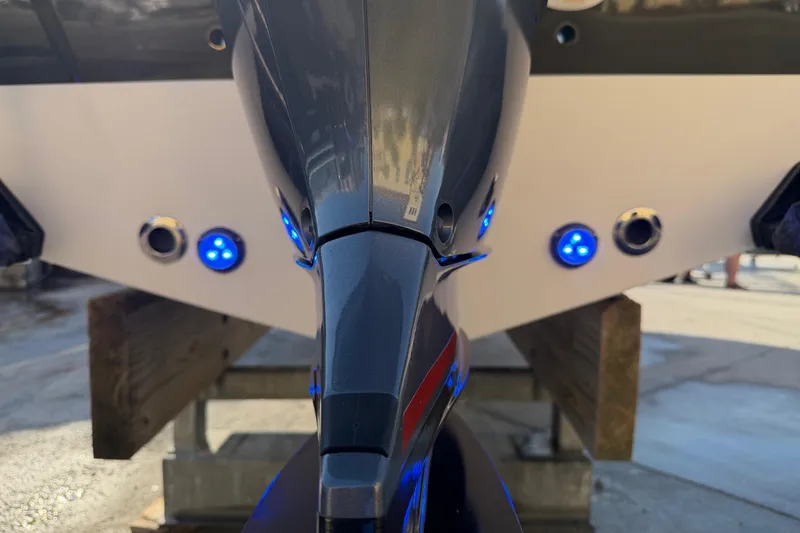 Slide: The Image of 2023 Sportsman Open 232 Center Console boat with blue LED lights on the stern. - 7