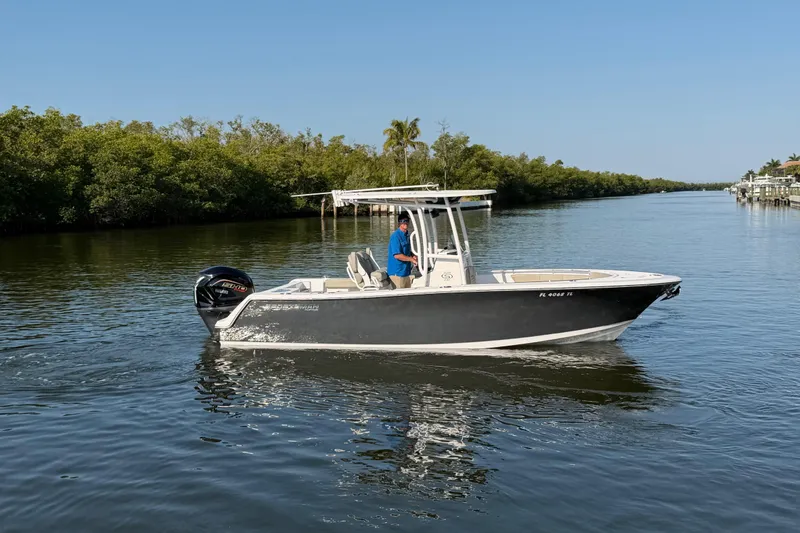 Slide: The Image of 2023 Sportsman Open 232 Center Console boat cruising on a calm river. - 8