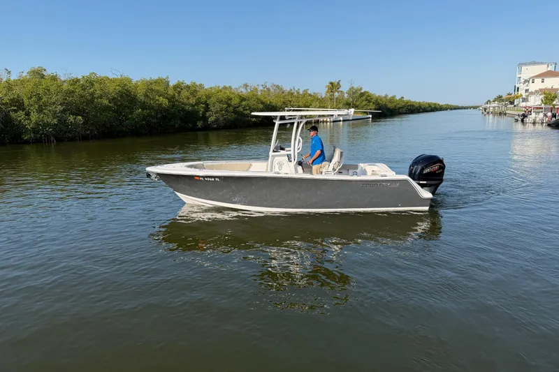 Slide: The Image of 2023 Sportsman Open 232 Center Console boat cruising on a calm waterway. - 9