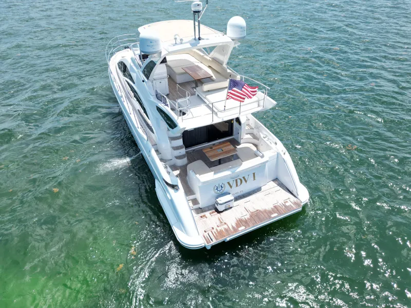 Slide: The Image of Azimut 54 Fly 2015 yacht cruising on open water, rear view with American flag. - 16