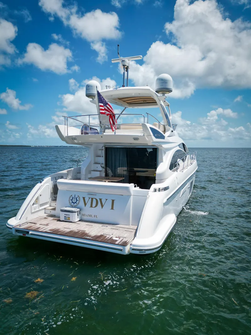 Slide: The Image of Azimut 54 Fly 2015 yacht cruising on open water under a clear blue sky. - 25