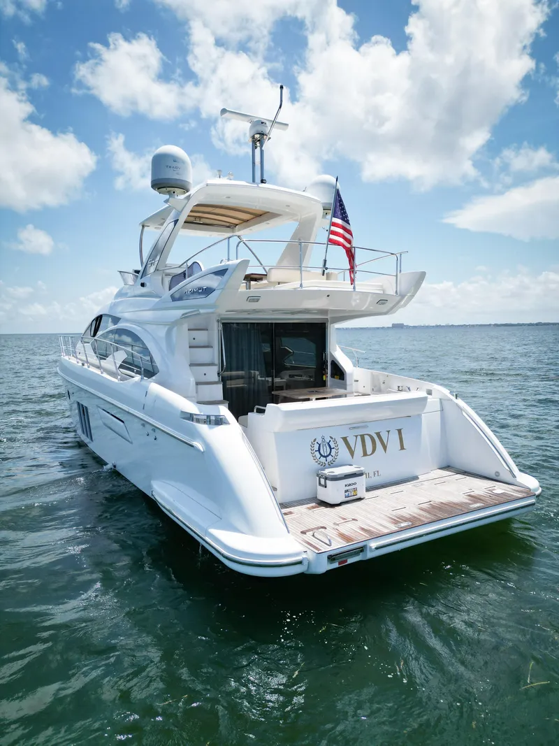Slide: The Image of Azimut 54 Fly 2015 yacht on water, rear view with American flag, clear sky. - 27