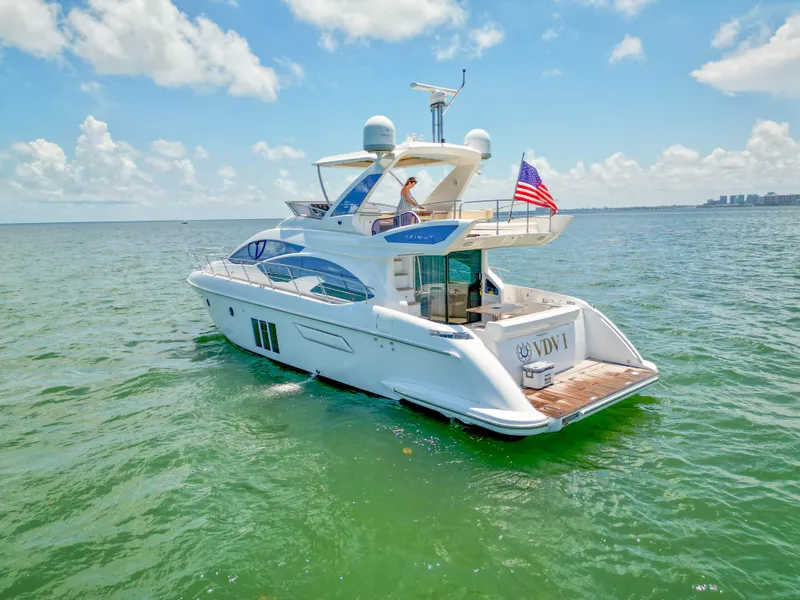 Slide: The Image of Azimut 54 Fly 2015 yacht cruising on open water under a clear blue sky. - 3