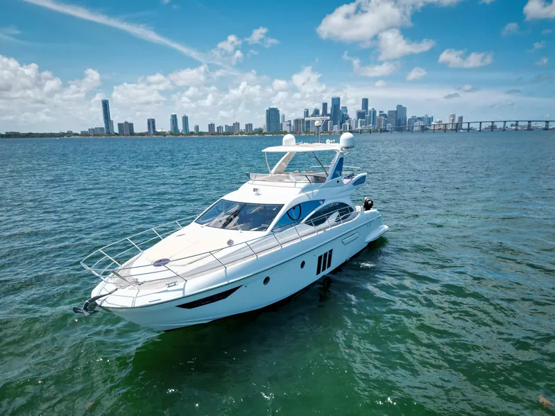 Slide: The Image of Luxury 2015 Azimut 54 Fly yacht cruising near city skyline under blue skies. - 31