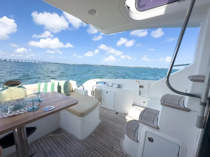 Slide: The Image of Azimut 54 Fly 2015 yacht deck with ocean view, featuring seating and table setup. - 34