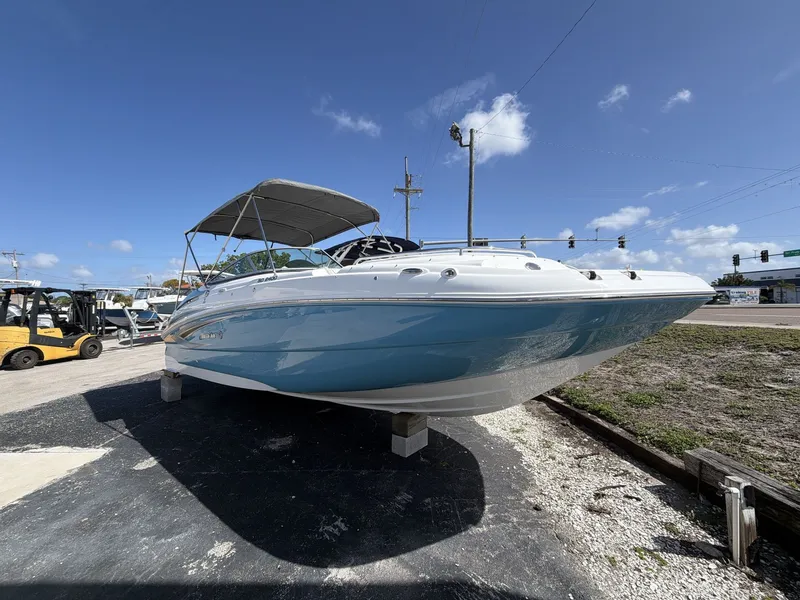 Slide: The Image of 2026 Hurricane 2400 SD boat on a parking lot under sunny skies. - 10