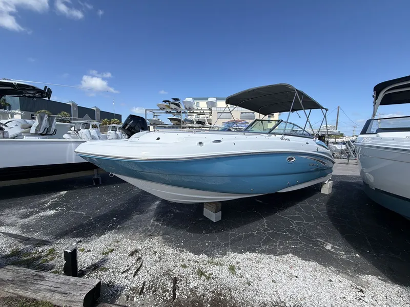 Slide: The Image of Hurricane 2400 SD 2026 boat on a lot under sunny skies. - 15