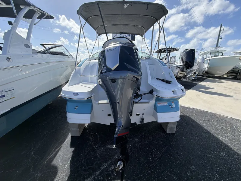 Slide: The Image of Hurricane 2400 SD 2026 boat with outboard motor at dock. - 18