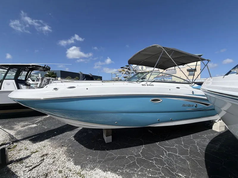 Slide: The Image of 2026 Hurricane 2400 SD boat with blue hull and sunshade. - 4