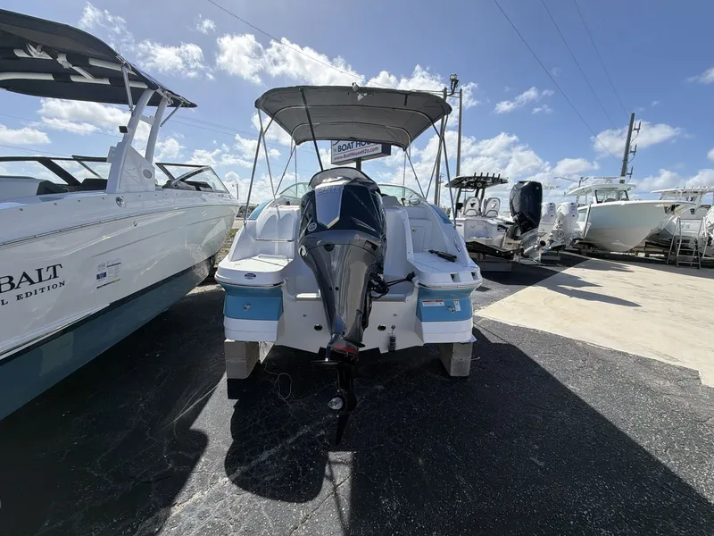 Slide: The Image of Hurricane 2400 SD 2026 boat parked under sunny skies. - 6