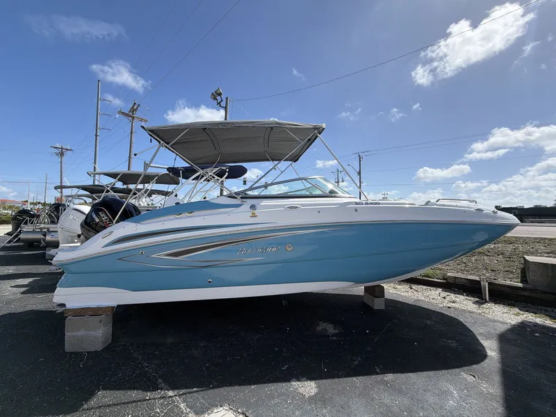 Slide: The Image of 2026 Hurricane 2400 SD boat on a lot under sunny skies. - 8