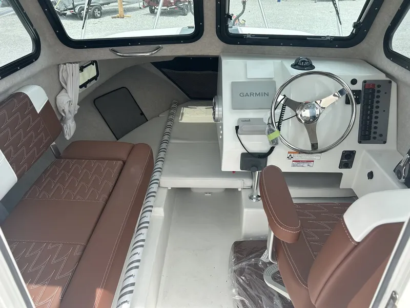 Slide: The Image of Interior of 2026 Parker 217 Explorer with AC and Garmin controls. - 8