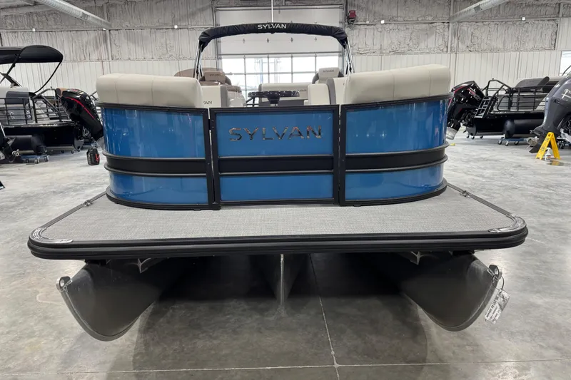 Slide: The Image of 2026 Sylvan Mirage X X5 pontoon boat in showroom, rear view. - 5