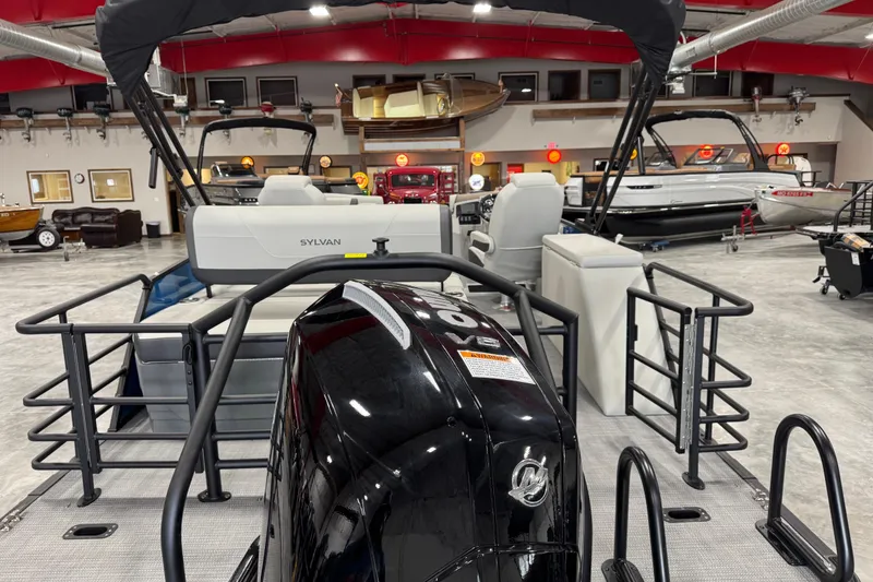Slide: The Image of 2026 Sylvan Mirage X X5 pontoon boat displayed in a showroom with modern interior. - 6