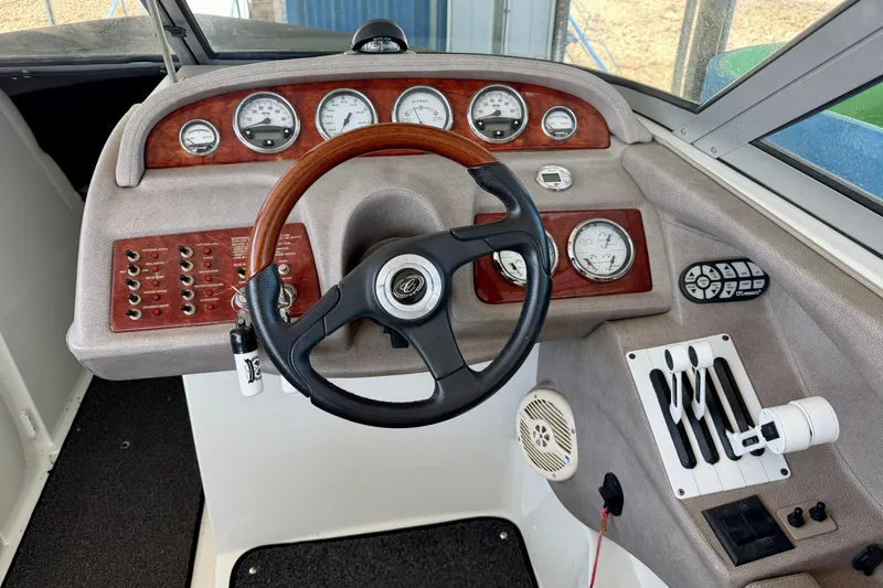 Slide: The Image of Dashboard of a 2005 Cobalt 282 boat with steering wheel and control gauges. - 10