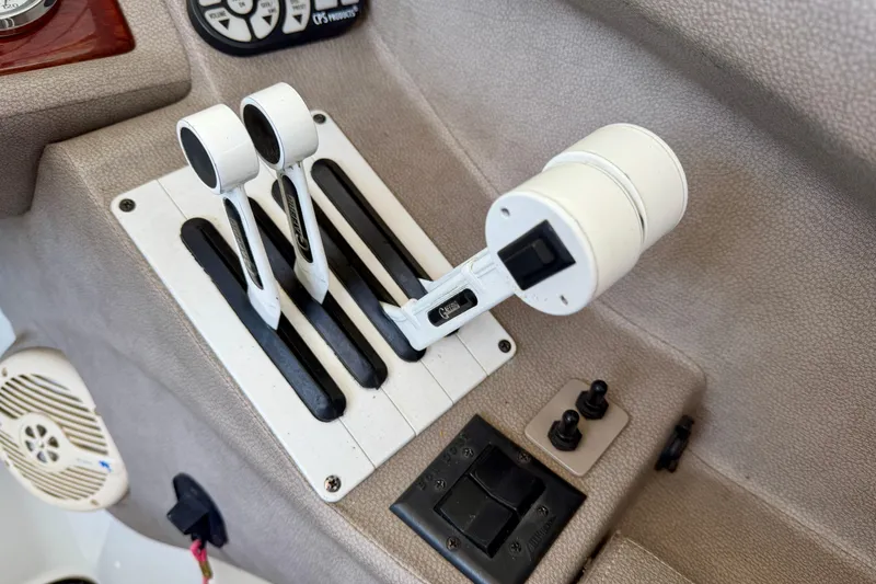 Slide: The Image of Boat throttle controls on a 2005 Cobalt 282 dashboard, featuring dual levers and switches. - 11